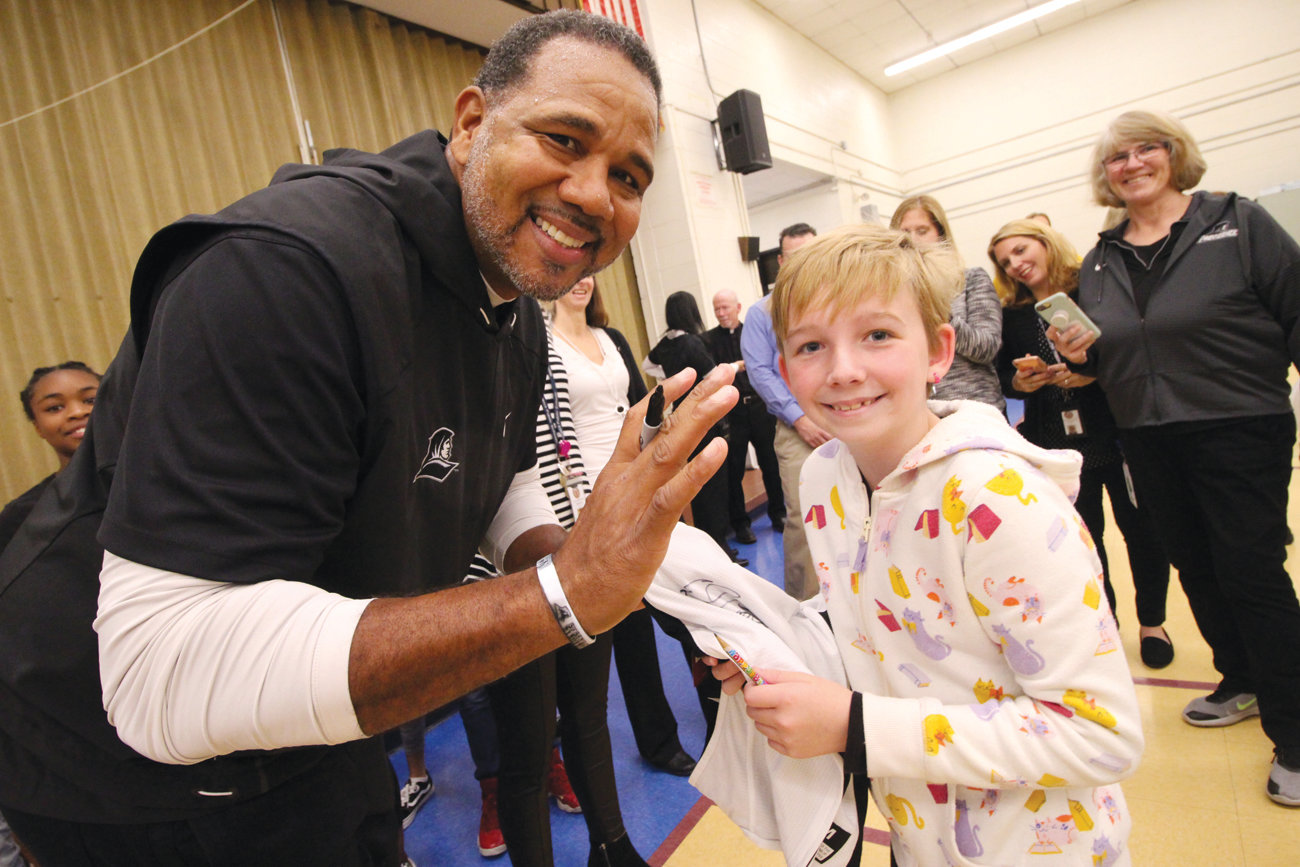 HE COULDN’T MISS HER: There was no question that Norwood second grader Bryna Lemonde is a Friars fan. She had drawn a PC on her cheek and Coach Cooley quickly picked her out of the crowd. They tried to place a surprise call to her father, but he could be reached and they were unable to leave a voice mail.